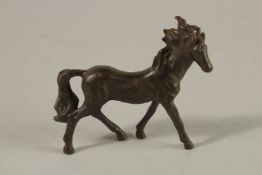 A BRONZE OKIMONO OF A HORSE.