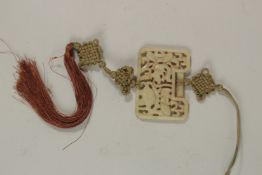 A FINE EARLY 20TH CENTURY CHING DYNASTY PIERCED CELADON JADE PLAQUE, depicting fish with original