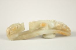 A CHINESE CARVED JADE CHILONG BELT BUCKLE, 8.5cm long.