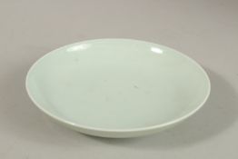A CHINESE CELADON GLAZE PORCELAIN DISH, with six-character mark, 15cm diameter.
