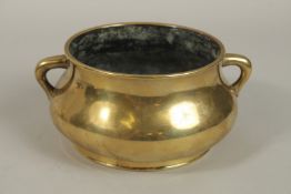 A CHINESE 18TH-19TH CENTURY GILT BRONZE TWIN HANDLE CENSER, the base cast with Xuande mark, 18cm
