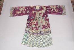 A FINE 19TH CENTURY CHINESE PURPLE SILK ROBE, embroidered with large dragon clutching the pearl of