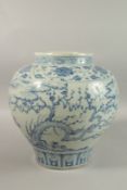 A LARGE CHINESE BLUE AND WHITE PORCELAIN JARDINIERE, painted with trees and clouds, 34cm high.