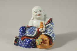 A 20TH CENTURY CHINESE PORCELAIN SEATED BUDDHA, with blue and white robes decorated with bats,