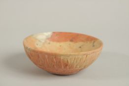 A PERSIAN SIGNED CARVED STONE BOWL, with radiating sun design to the exterior, the base with incised
