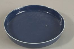 A CHINESE POWDER BLUE PORCELAIN DISH, six-character mark, 19.3cm diameter.