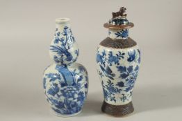 TWO CHINESE BLUE AND WHITE PORCELAIN VASES, one with cover, each depicting birds and flora,