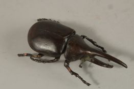 A BRONZE OKIMONO OF A RHINOCEROS BEETLE.