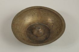 AN 18TH-19TH CENTURY PERSIAN ENGRAVED BRASS MAGIC BOWL, 15cm diameter.