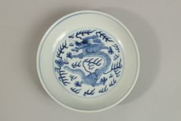 A FINE 19TH CENTURY CHINESE PORCELAIN DRAGON DISH, with four-character mark to base, 16cm diameter.