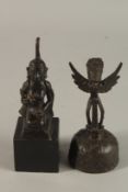 A BRONZE KNEELING BUDDHISTIC FIGURE ON WOODEN BASE, together with a bronze bell, (2).