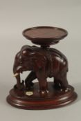 A FINE 19TH CENTURY INDIAN CARVED WOOD ELEPHANT STAND, with ivory inlays, 19cm high.