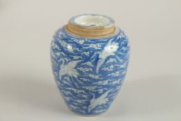 A 19TH CENTURY CHINESE BLUE AND WHITE PORCELAIN JAR AND COVER, with cranes in flights and stylised