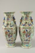 A PAIR OF CHINESE CANTON FAMILLE ROSE PORCELAIN HEXAGONAL VASES, painted with panels of figures