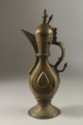 A FINE 19TH CENTURY CENTRAL ASIAN BUKHARA ENGRAVED BRASS EWER, 36cm high.
