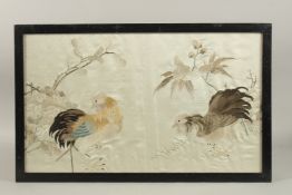 A CHINESE EMBROIDERED SILK PANEL, depicting two hens, framed and glazed, 38cm x 61cm overall.