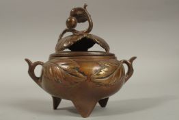 A CHINESE BRASS TWIN HANDLE CENSER AND COVER, 11cm high.