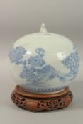 A LARGE JAPANESE ARITA BLUE AND WHITE PORCELAIN BULBOUS JAR AND COVER ON HARDWOOD STAND, finely