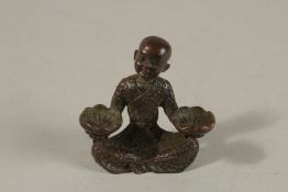 A BRONZE OKIMONO OF A SEATED FIGURE.