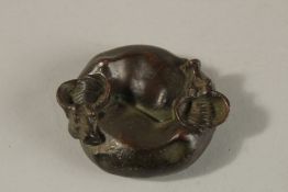 A BRONZE OKIMONO OF ENTWINED WATER BUFFALO, the reverse with yin yang symbol.