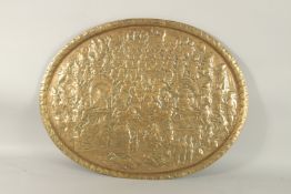 A LARGE 19TH CENTURY NORTH INDIAN EMBOSSED BRASS TRAY, depicting a battle scene from the Ramayana