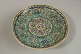 A FINE LARGE EARLY 20TH CENTURY PALESTINIAN JERUSALEM GLAZED POTTERY CHARGER, 30cm wide.