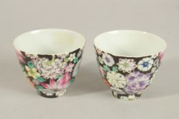 A PAIR OF CHINESE QING DYNASTY POLYCHROME FLORAL TEA CUPS, each with character mark to base, 7.5cm