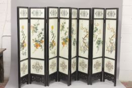 A PAIR OF CHINESE LACQUERED FOUR-PANEL FOLDING SCREENS, relief decorated and painted with birds