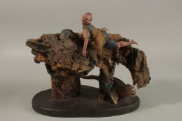 AN UNUSUAL JAPANESE ROOT WOOD SCULPTURAL GROUP, depicting a figure atop the wooden mound with