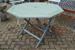 A pale green painted octagonal shaped folding garden table.