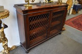 In the manner of Gillows, a 19th century mahogany bookcase with brass galleried top, pair of brass