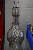 A four section decanter with plated mounts.