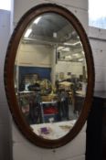 An oval wall mirror.