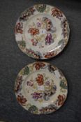 A pair of floral decorated iron stone plates.