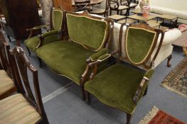An Edwardian inlaid mahogany three piece salon suite.