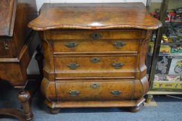 A good 18th century Dutch walnut commode of bombay form with three drawers on bun feet.