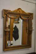Decorative over mantel mirror with pair of light fittings.