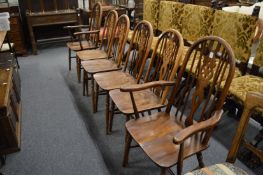 A set of six Old Charm wheel back dining chairs, two with arms.
