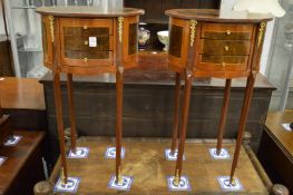 A pair of French style mahogany oval three drawer bedside tables.