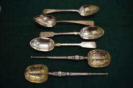 A pair of silver serving spoons and four silver tablespoons.
