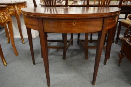 A 19th century mahogany demi lune fold-over tea table.