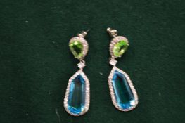 A pair of simulated peridot and aquamarine drop earrings.