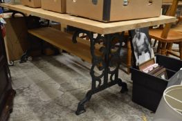 A pine rectangular kitchen table with cast iron supports.