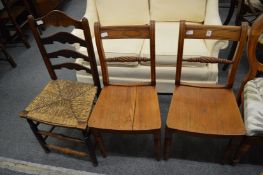 A pair of 19th century elm dining chairs and a ladder back chair.