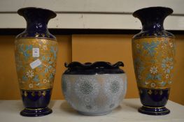 A pair of Doulton vases and similar jardiniere (one vase repaired).