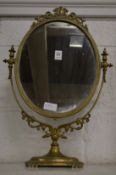 A brass framed dressing table mirror.