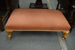 A long upholstered foot stool.