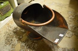 A copper coal scuttle.