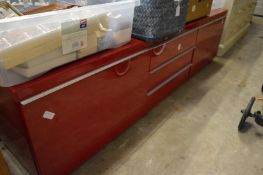 A red lacquer wide screen TV unit.