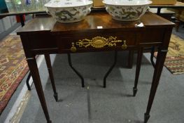 A mahogany breakfront single drawer side table.